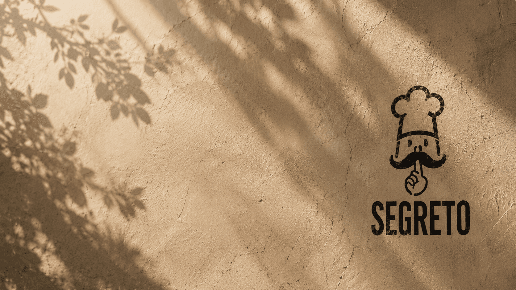 Segreto logo on a sunlit textured wall